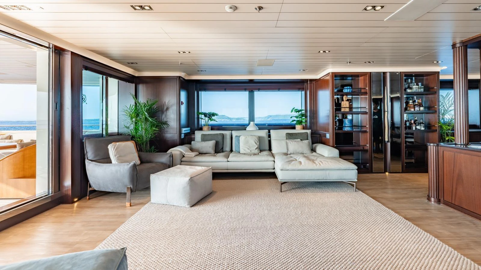 The spacious salon features elegant furnishings and expansive windows offering stunning ocean views. aboard GALILEO Yacht for Sale