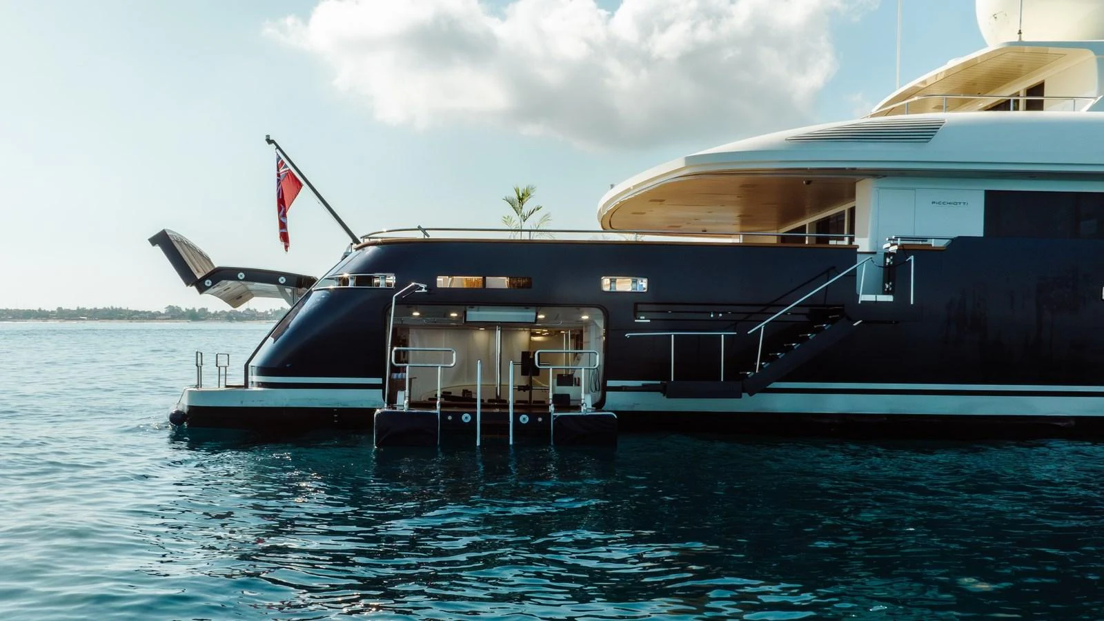 A sleek yacht with a swim platform and steps leading into the water, perfect for enjoying the sea. aboard GALILEO Yacht for Sale