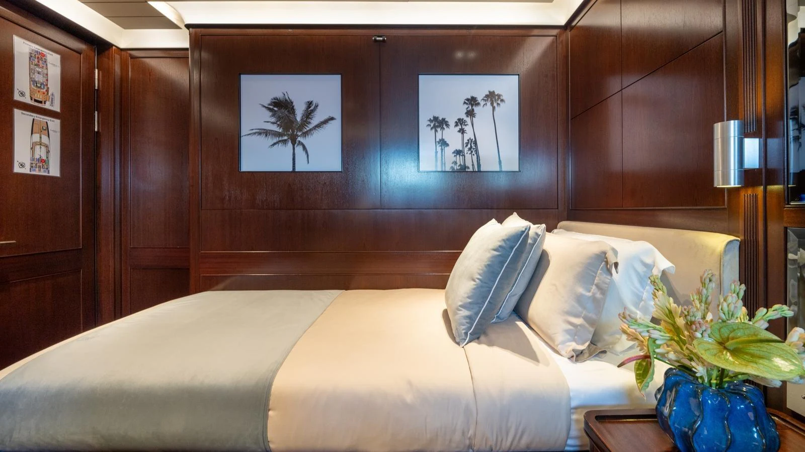 The stateroom features a luxurious bed with elegant wooden paneling and tasteful decor. aboard GALILEO Yacht for Sale