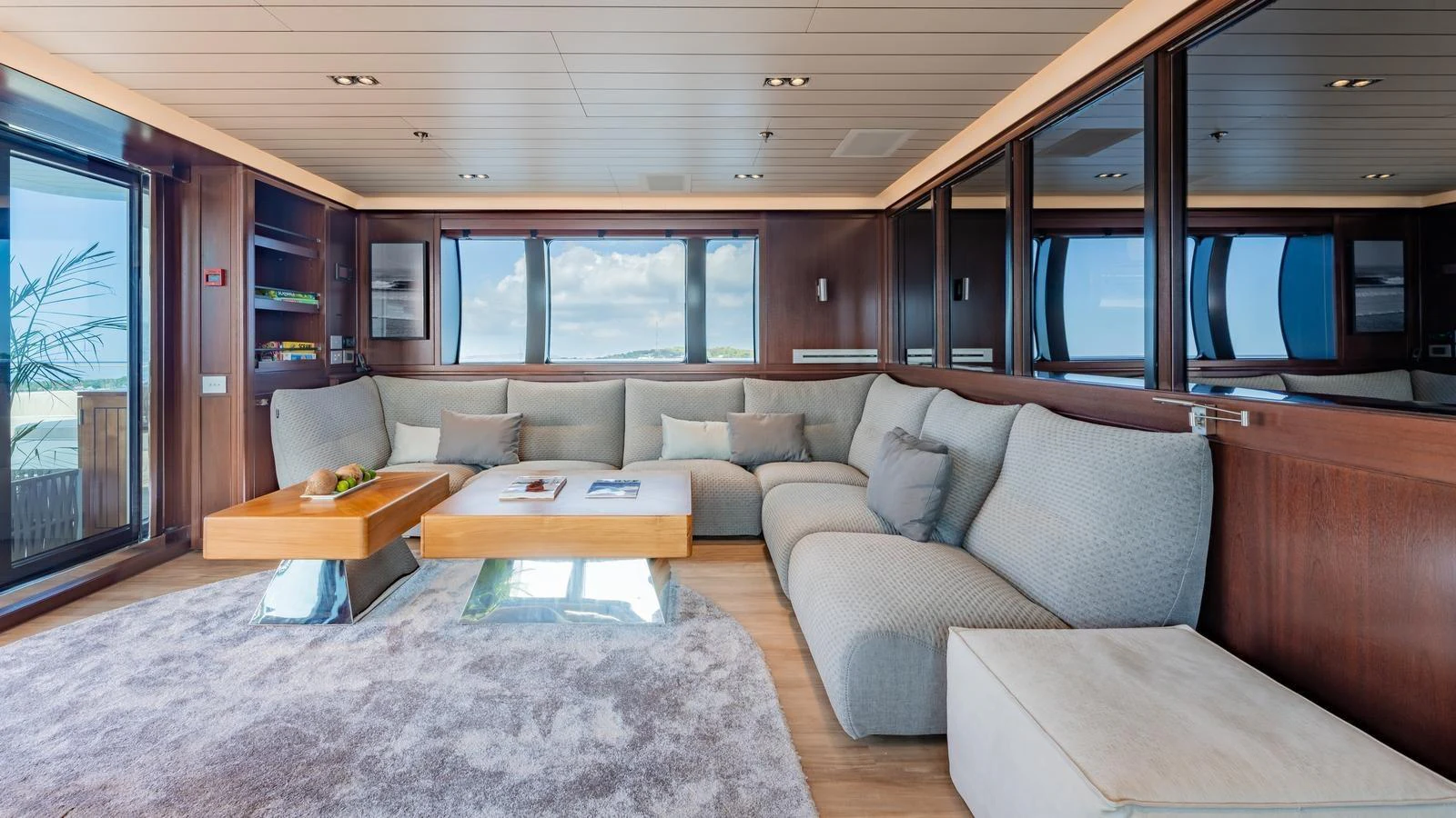 The salon features a spacious and elegant seating area with large windows offering stunning views. aboard GALILEO Yacht for Sale