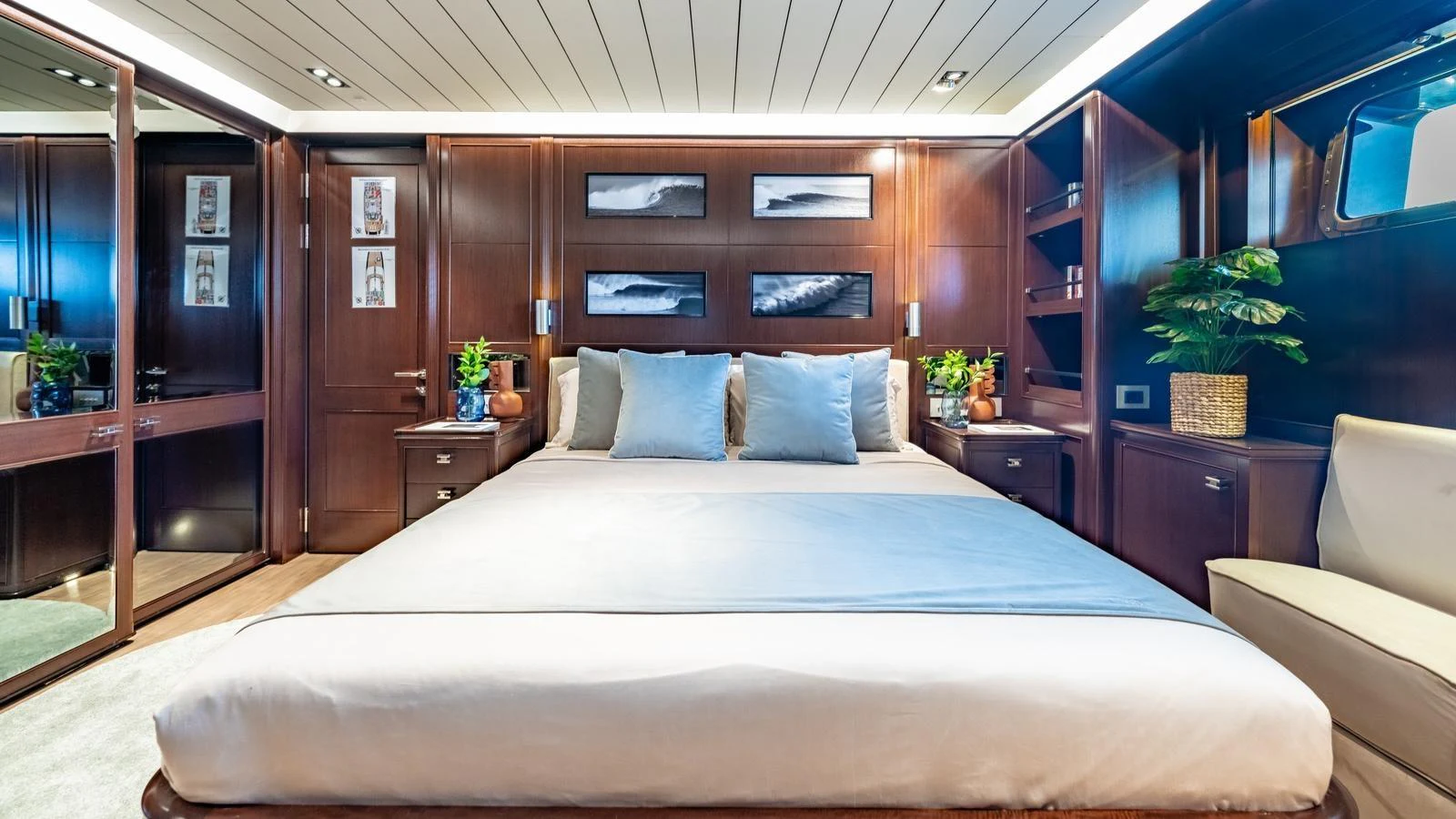 The master stateroom features a luxurious bed with elegant wood paneling and modern decor. aboard GALILEO Yacht for Sale