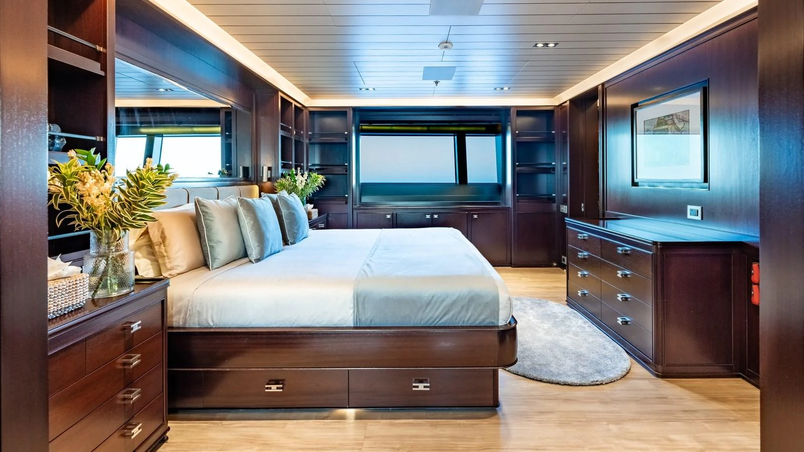 The master stateroom features a spacious bed, elegant wood finishes, and ample storage, creating a luxurious and comfortable retreat. aboard GALILEO Yacht for Sale