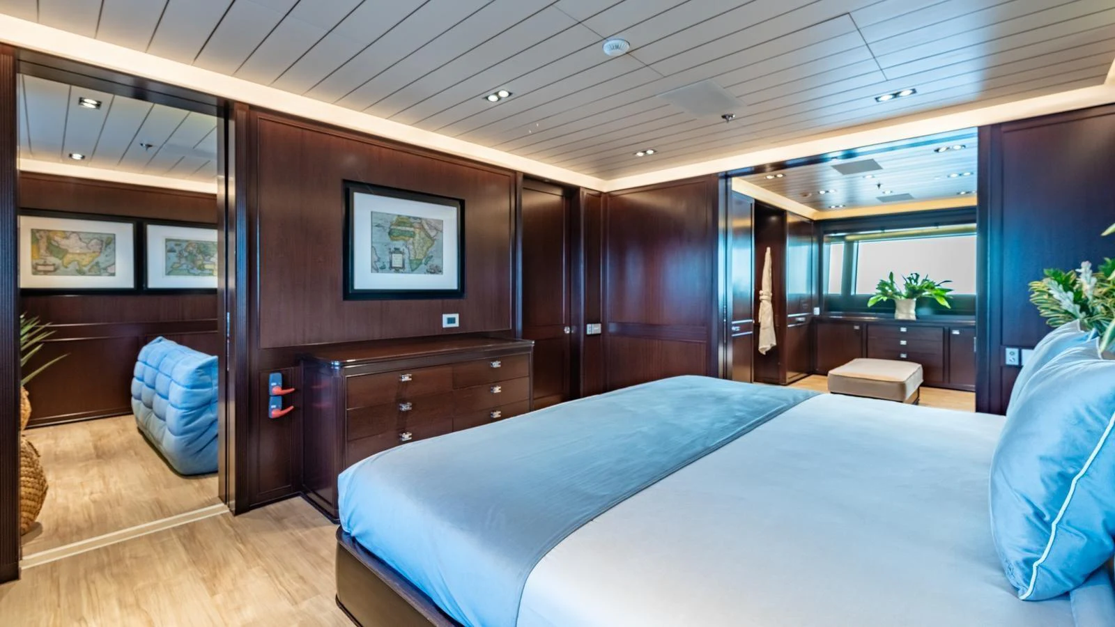 The master stateroom features elegant wood paneling, a large bed, and tasteful decor. aboard GALILEO Yacht for Sale
