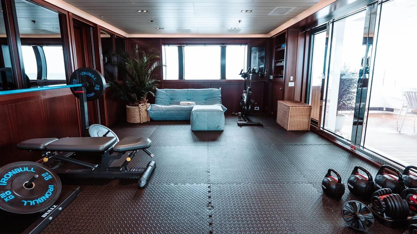 The yacht features a well-equipped gym with modern fitness equipment and a comfortable seating area. aboard GALILEO Yacht for Sale