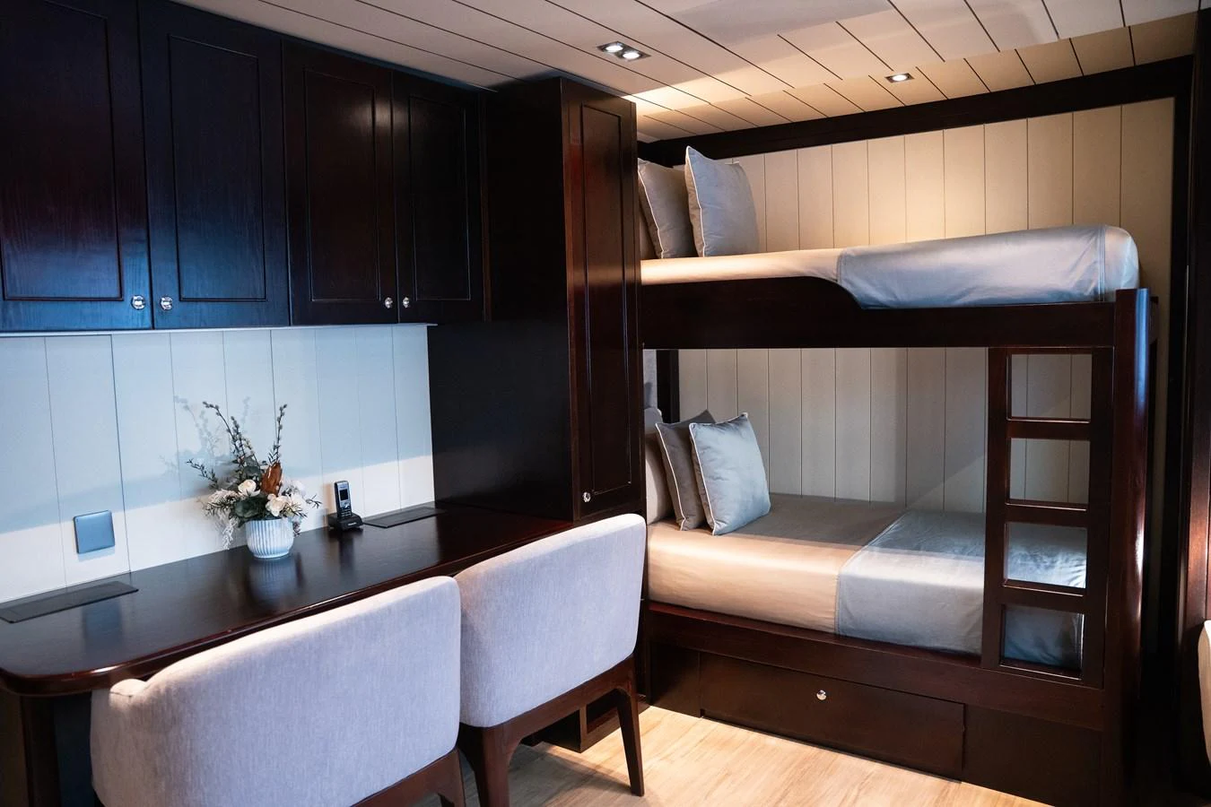 The guest cabin features cozy bunk beds and a functional desk area, creating a welcoming and practical space. aboard GALILEO Yacht for Sale
