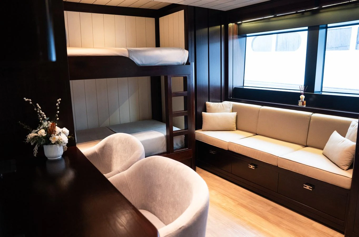 The guest cabin features cozy bunk beds, a comfortable sofa, and elegant decor. aboard GALILEO Yacht for Sale
