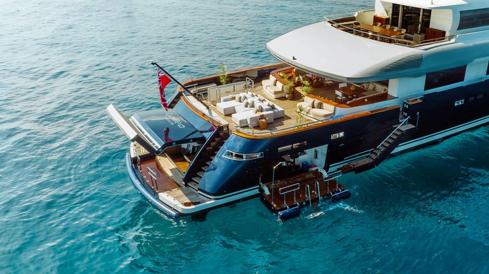 The yacht's aft deck features an inviting lounge area with direct access to the water. aboard GALILEO Yacht for Sale