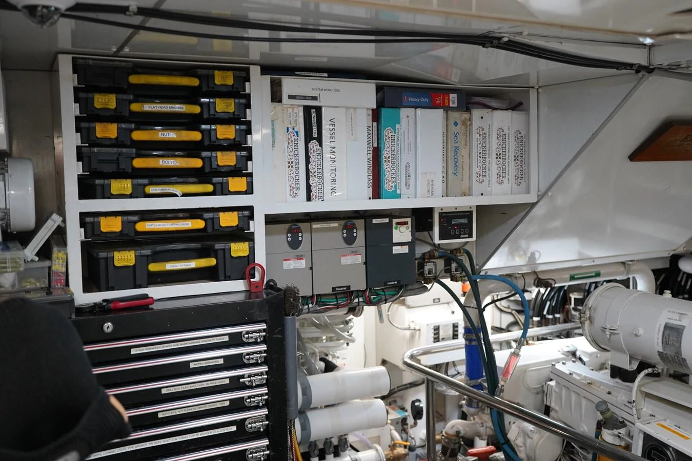 The image showcases the well-organized engine room of the yacht, featuring various tools and equipment. aboard KNICKERBOCKER Yacht for Sale