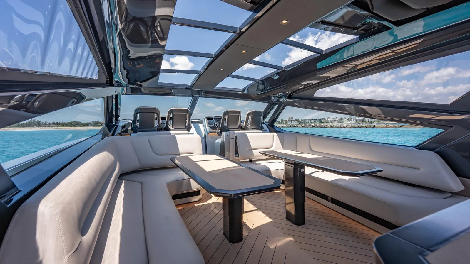 The yacht's saloon features luxurious seating with panoramic views and a retractable roof. aboard RESOLUTE Yacht for Sale