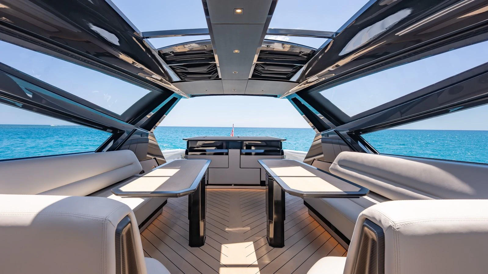 The yacht's saloon offers a spacious and modern seating area with panoramic ocean views. aboard RESOLUTE Yacht for Sale