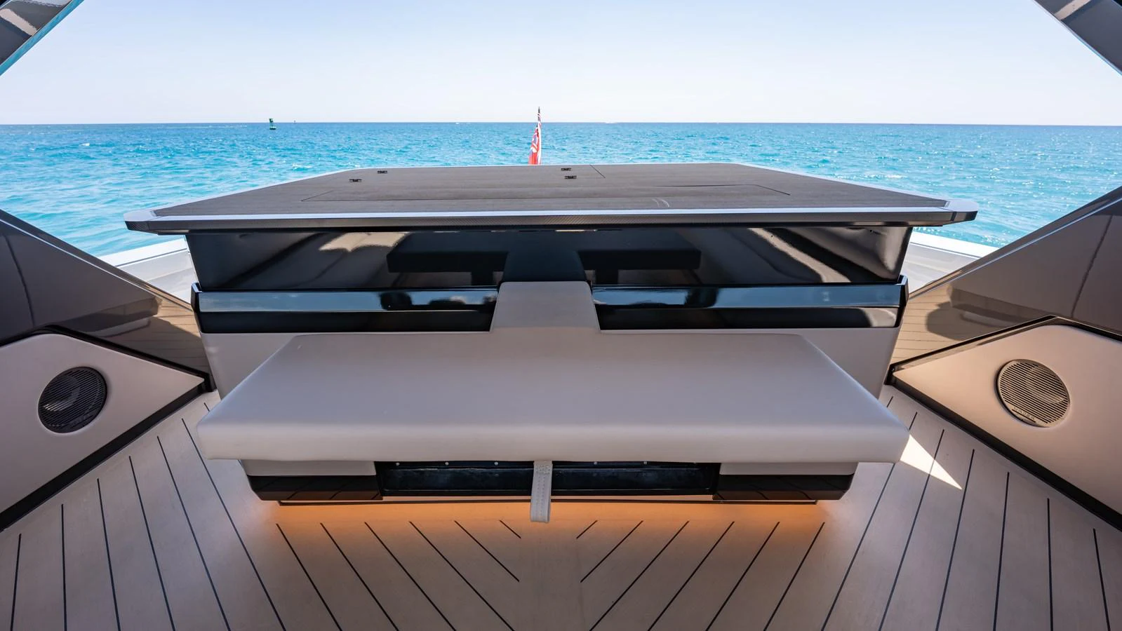 The aft deck features a sleek, modern design with a fold-out table and stunning ocean views. aboard RESOLUTE Yacht for Sale