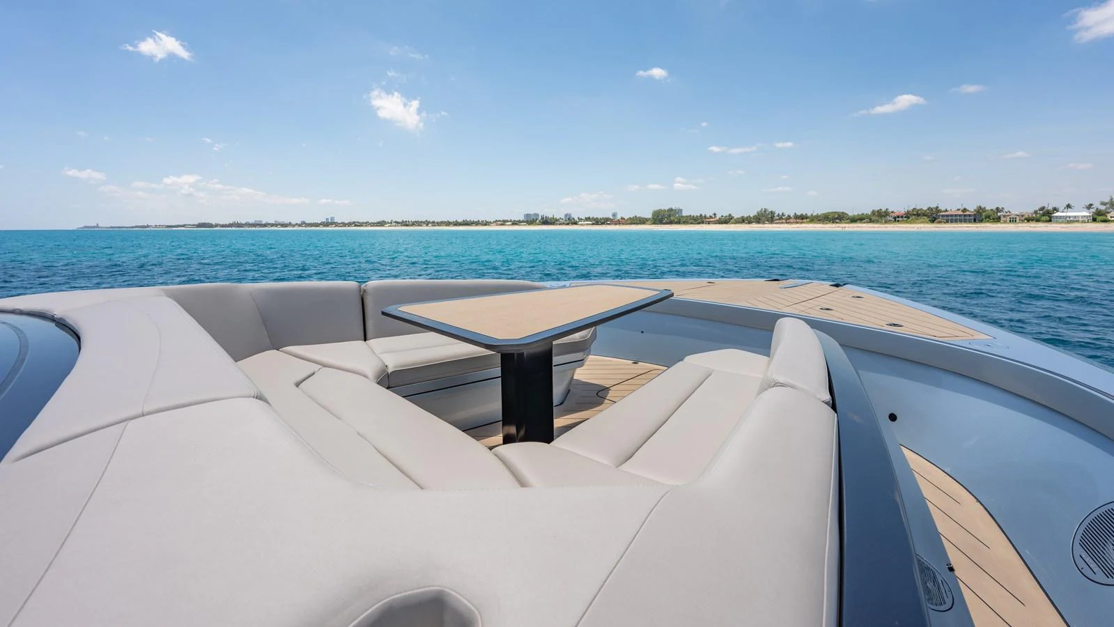 The aft deck features a spacious seating area with a central table, perfect for enjoying the scenic views. aboard RESOLUTE Yacht for Sale