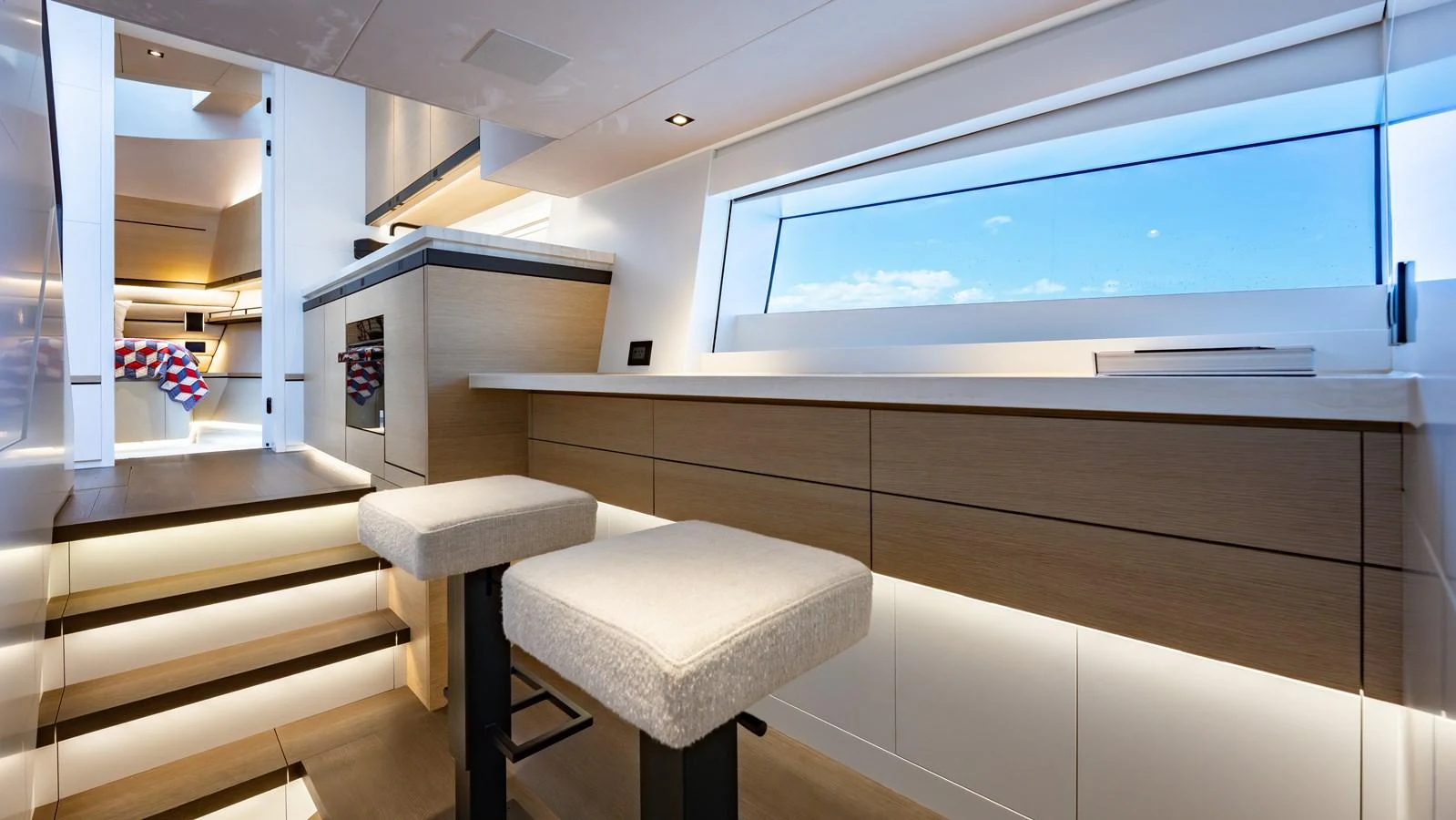 The modern galley features sleek cabinetry and a large window offering stunning sea views. aboard RESOLUTE Yacht for Sale