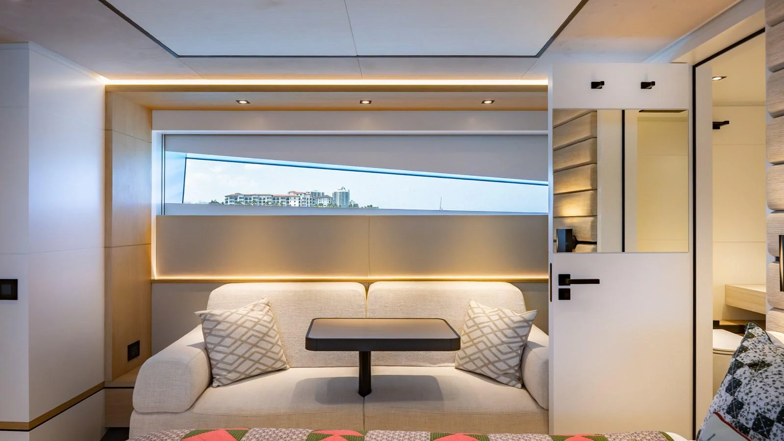 The salon features a cozy seating area with a modern design and ample natural light. aboard RESOLUTE Yacht for Sale