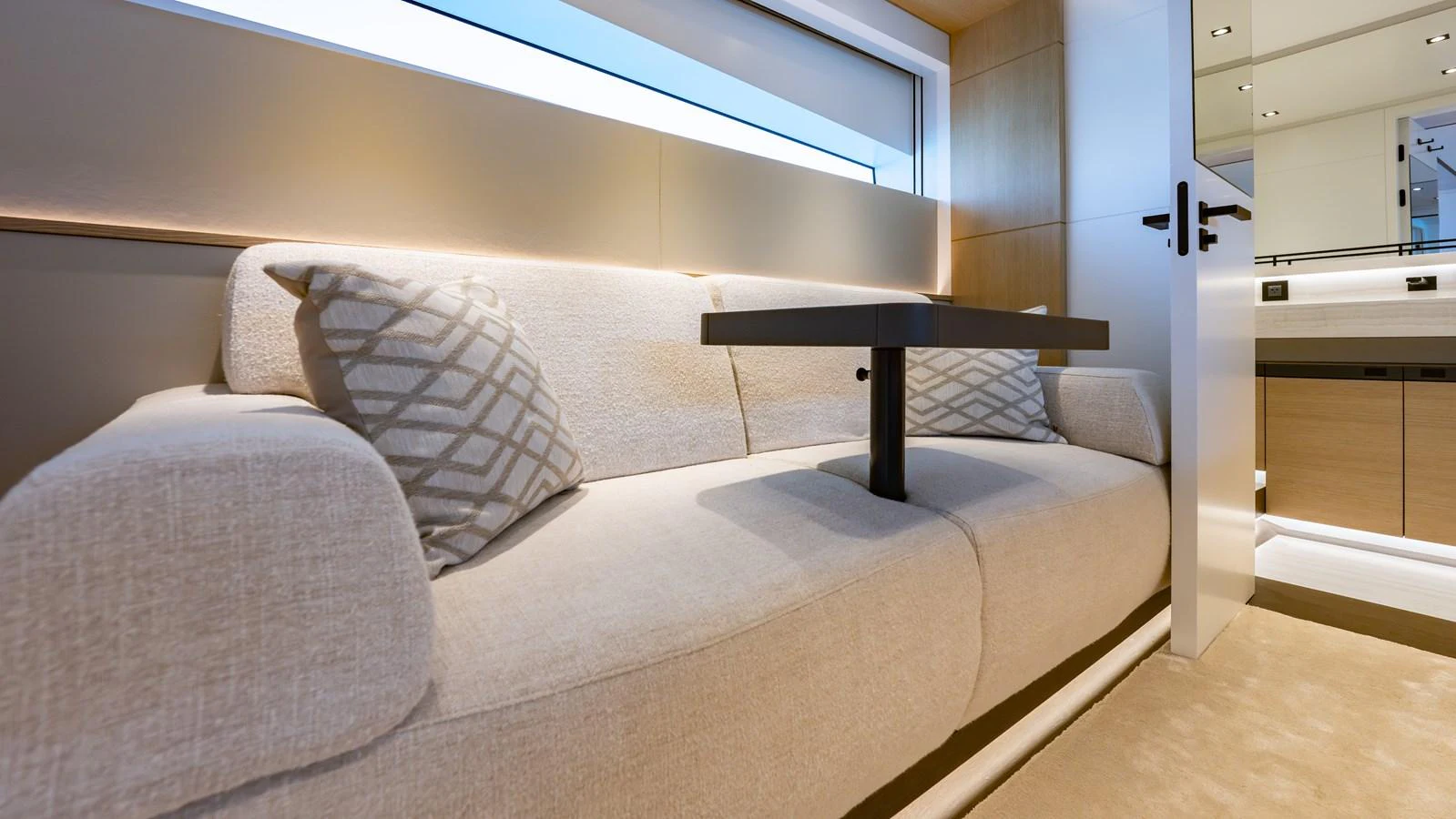 The yacht's interior features a cozy seating area with a modern design and ample natural light. aboard RESOLUTE Yacht for Sale