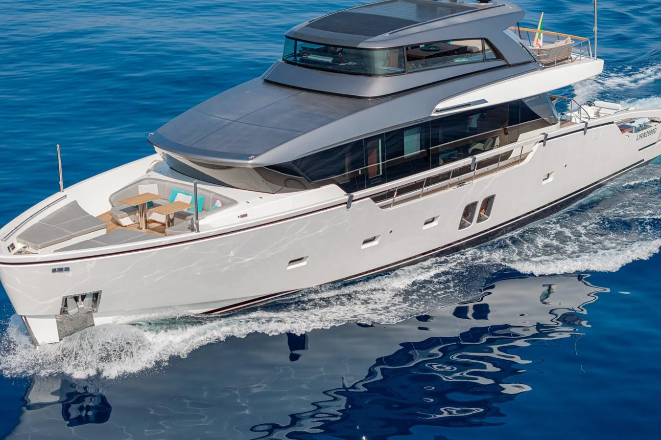 A sleek and modern yacht glides effortlessly over the calm blue waters. aboard M&M Yacht for Sale