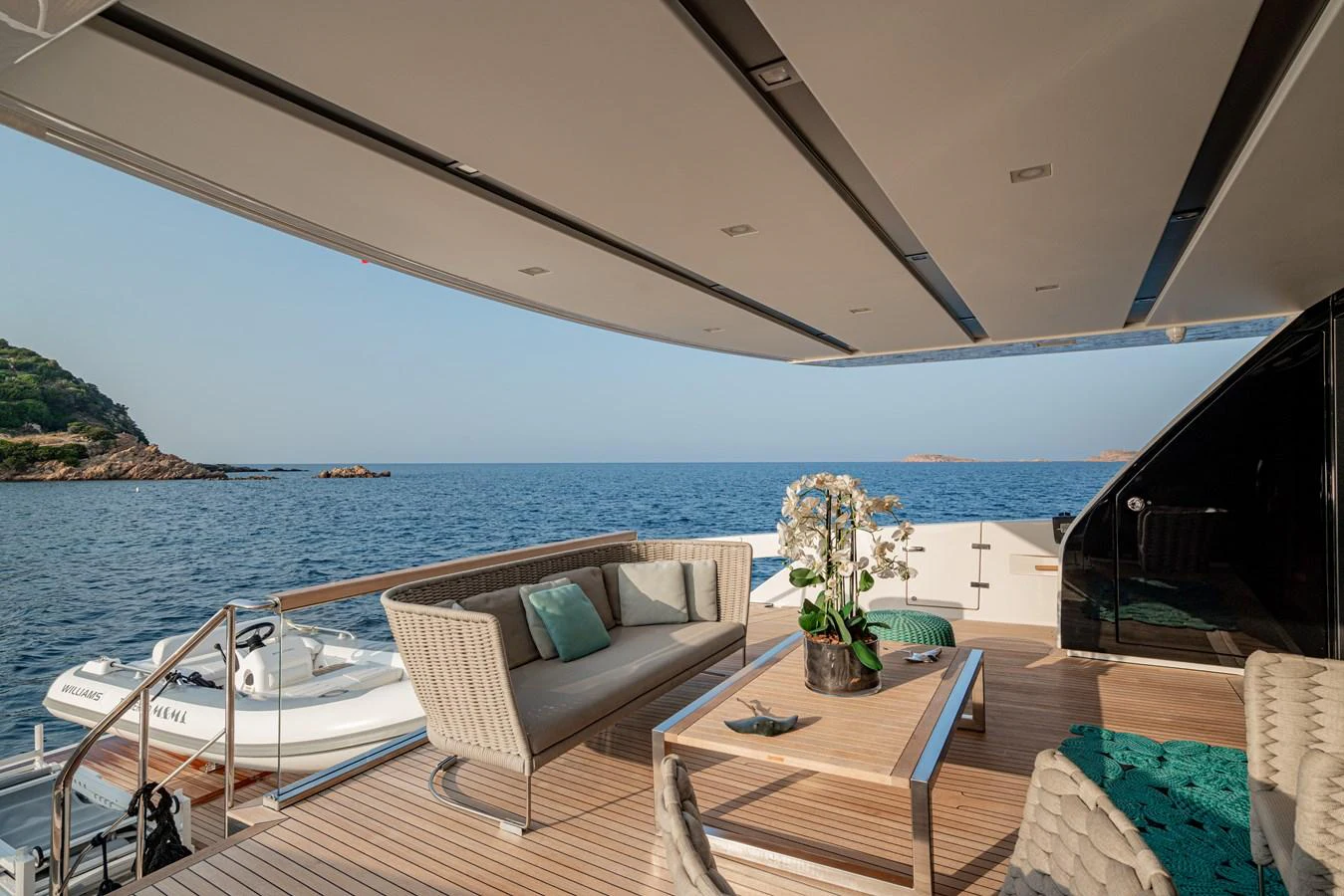 The aft deck offers a luxurious seating area with stunning ocean views. aboard M&M Yacht for Sale