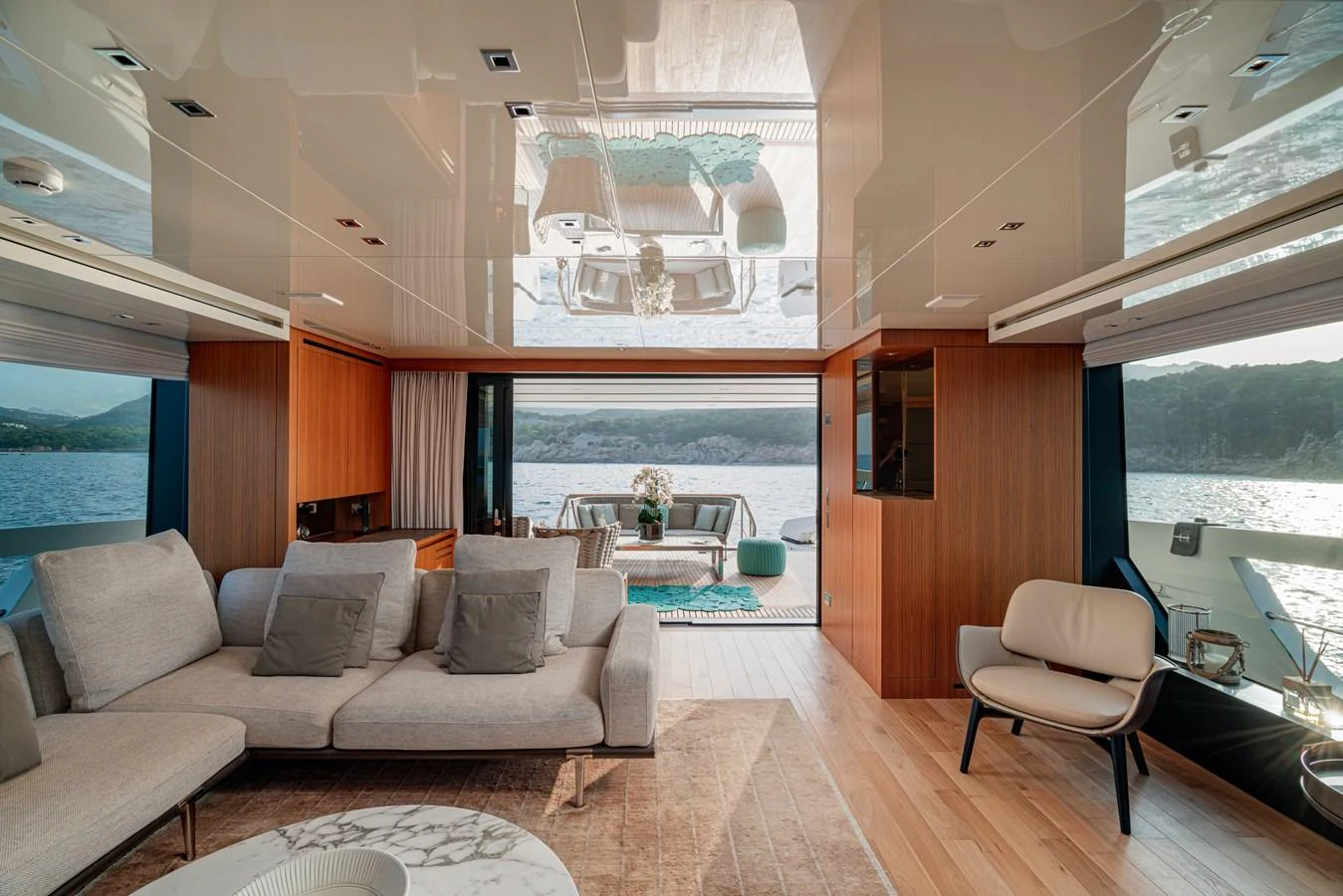 The salon features a spacious and elegant seating area with panoramic views of the water. aboard M&M Yacht for Sale