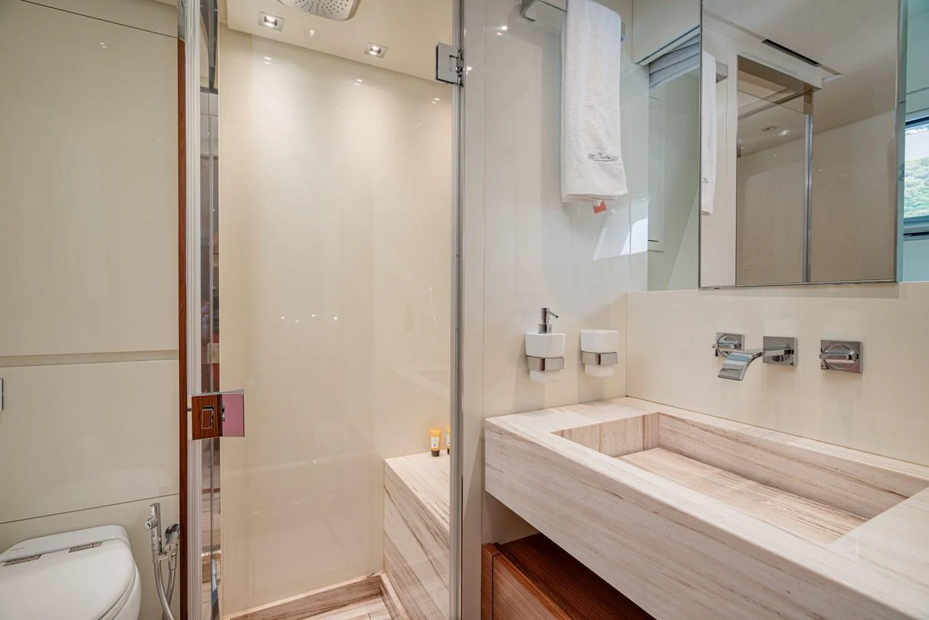 The yacht's bathroom features a sleek, modern design with high-end fixtures and a spacious shower. aboard M&M Yacht for Sale