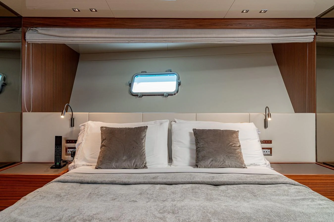 The stateroom features a plush bed with elegant bedding and ample natural light from a side window. aboard M&M Yacht for Sale