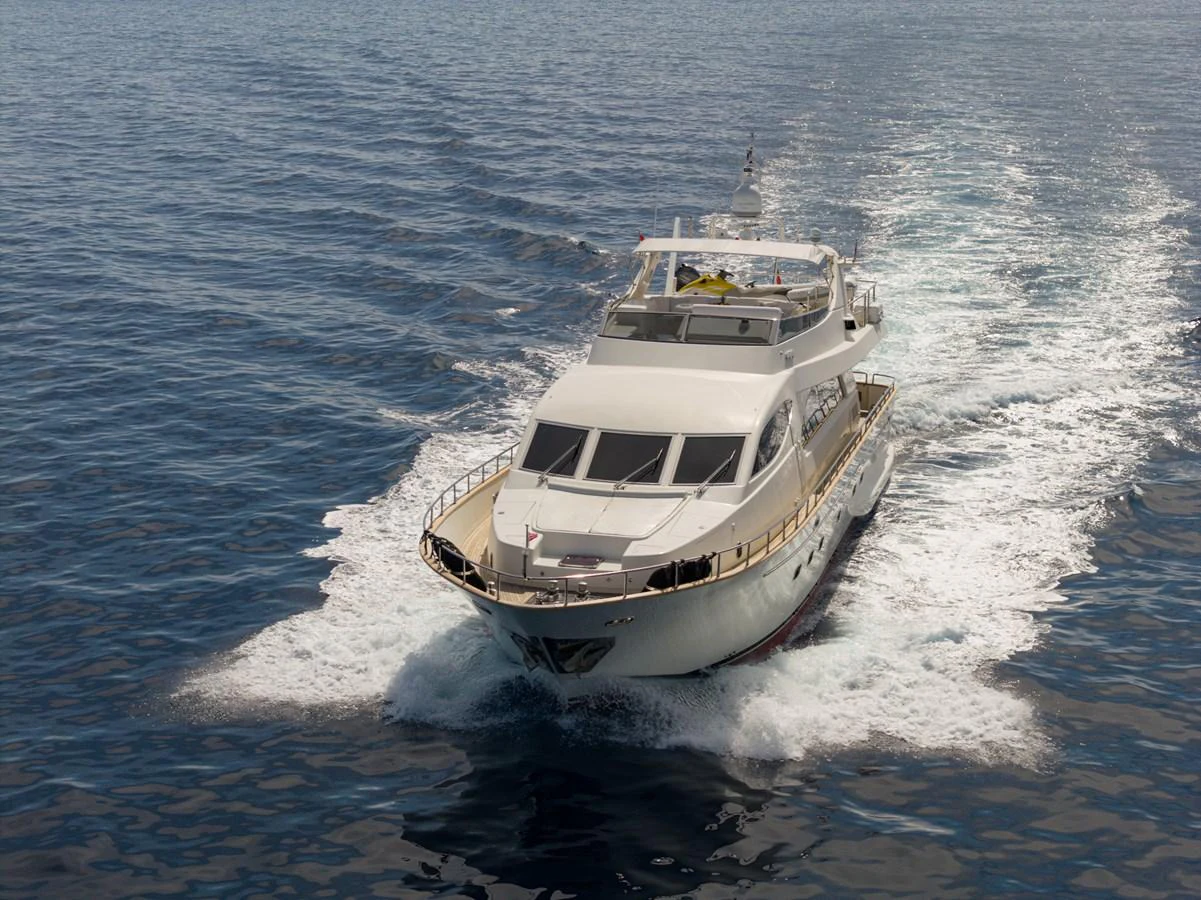 A luxurious yacht cruises smoothly through calm waters, showcasing its elegant design and spacious deck. aboard LADY MAUREEN Yacht for Sale