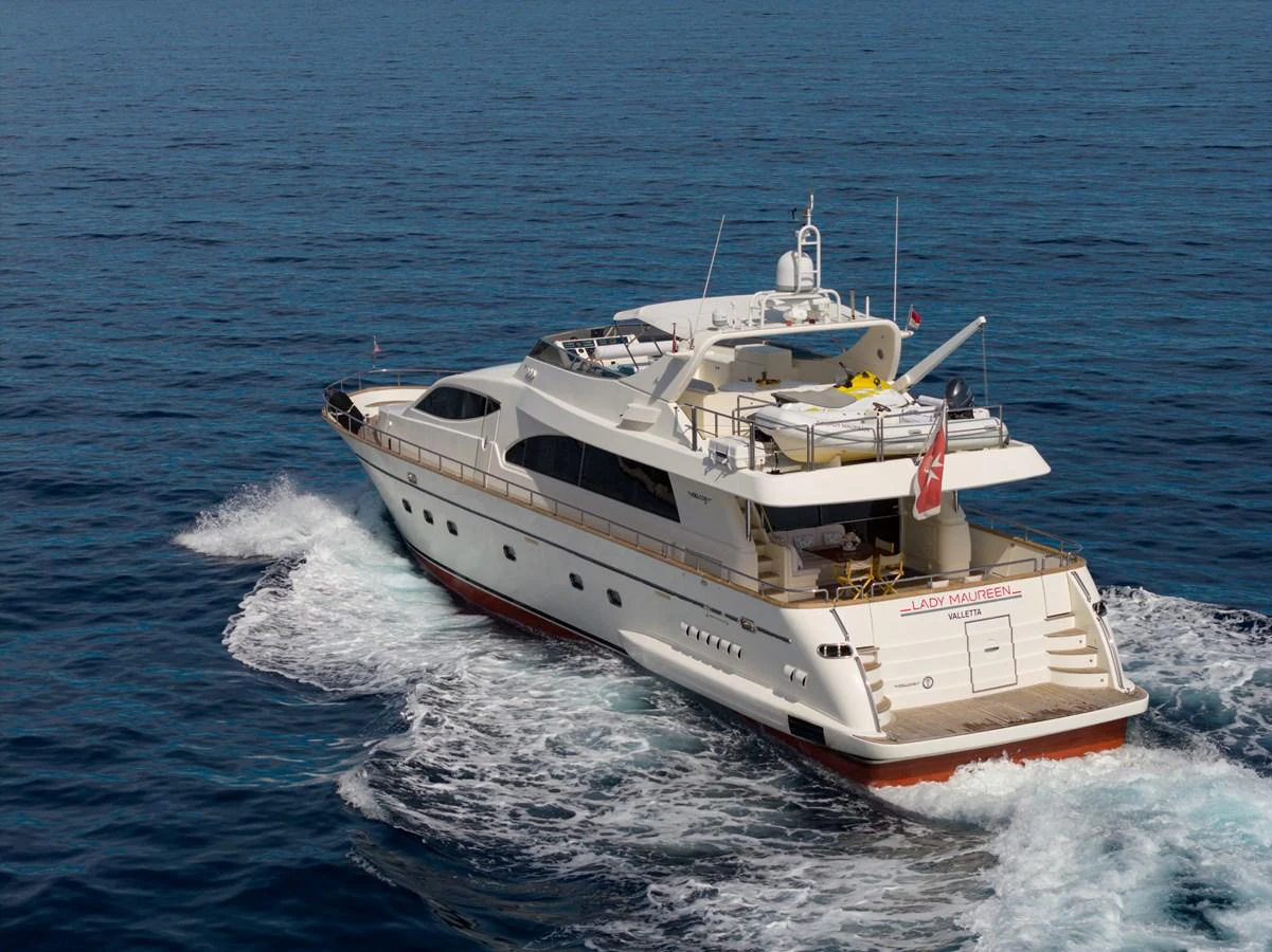 A luxurious yacht cruises through the open sea, showcasing its elegant design and spacious deck areas. aboard LADY MAUREEN Yacht for Sale