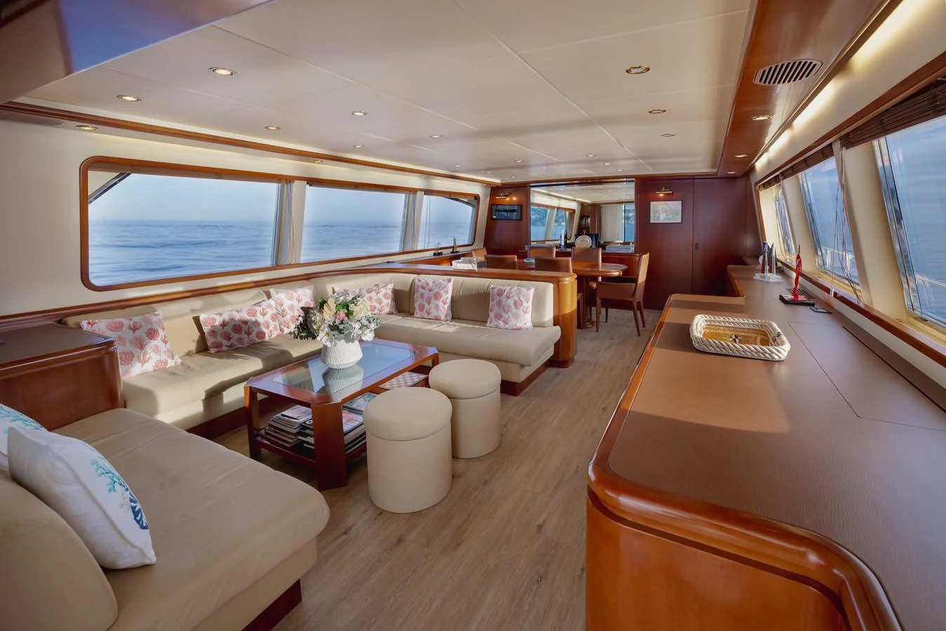 The yacht's salon features plush seating, elegant decor, and expansive windows offering stunning ocean views. aboard LADY MAUREEN Yacht for Sale