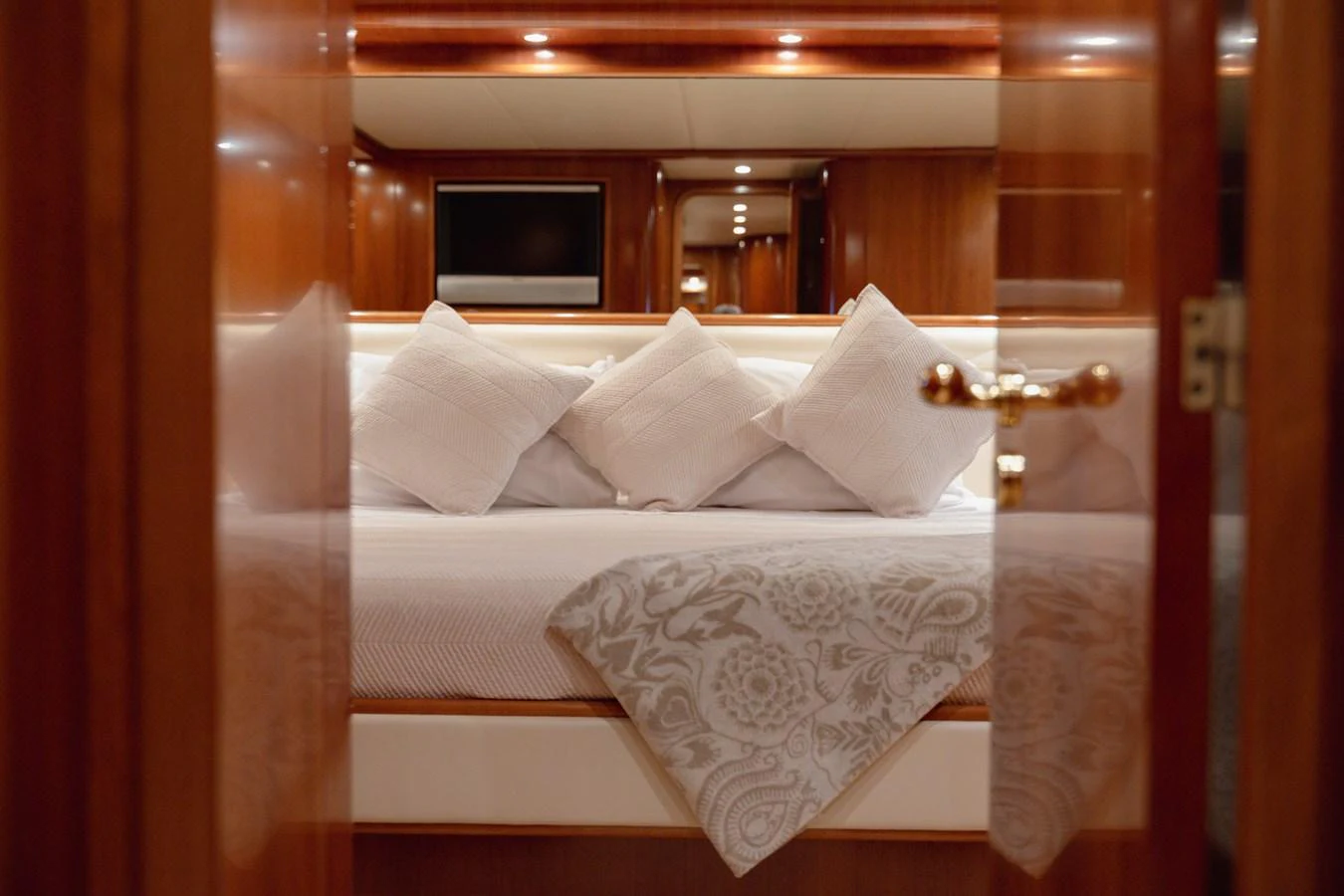 A luxurious stateroom featuring a plush bed with elegant bedding and soft lighting. aboard LADY MAUREEN Yacht for Sale