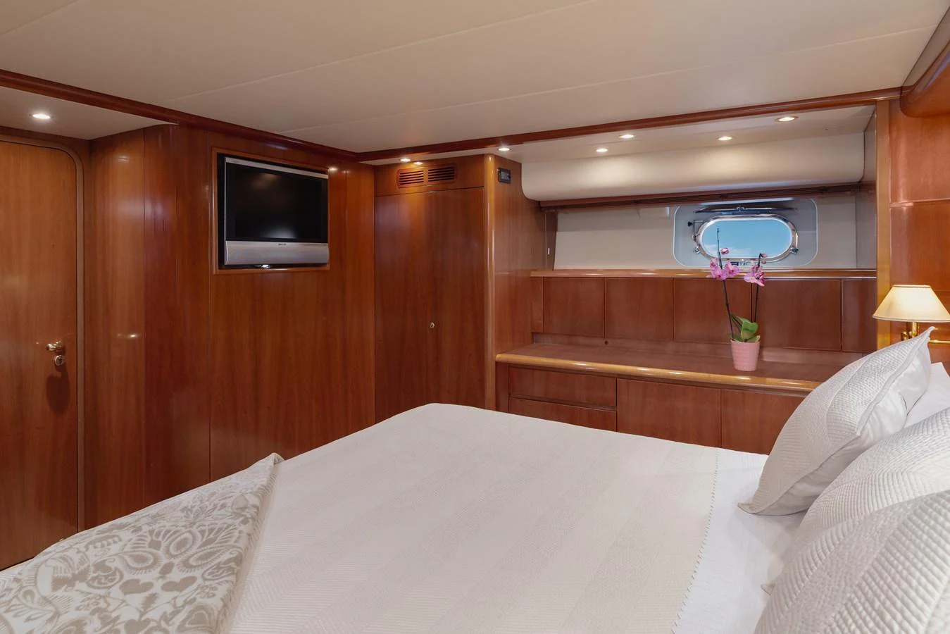 A cozy stateroom with elegant wood paneling and a comfortable bed. aboard LADY MAUREEN Yacht for Sale