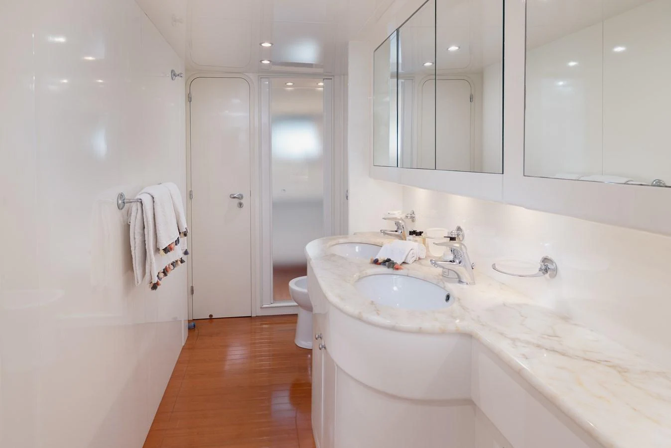 The yacht's bathroom features a sleek design with a double sink and elegant marble countertops. aboard LADY MAUREEN Yacht for Sale