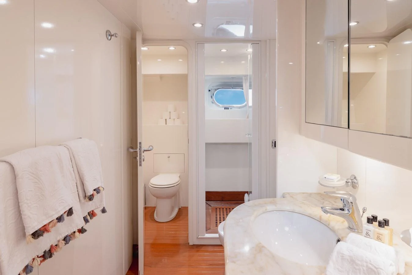 The yacht's bathroom features a sleek design with a marble countertop and modern fixtures. aboard LADY MAUREEN Yacht for Sale