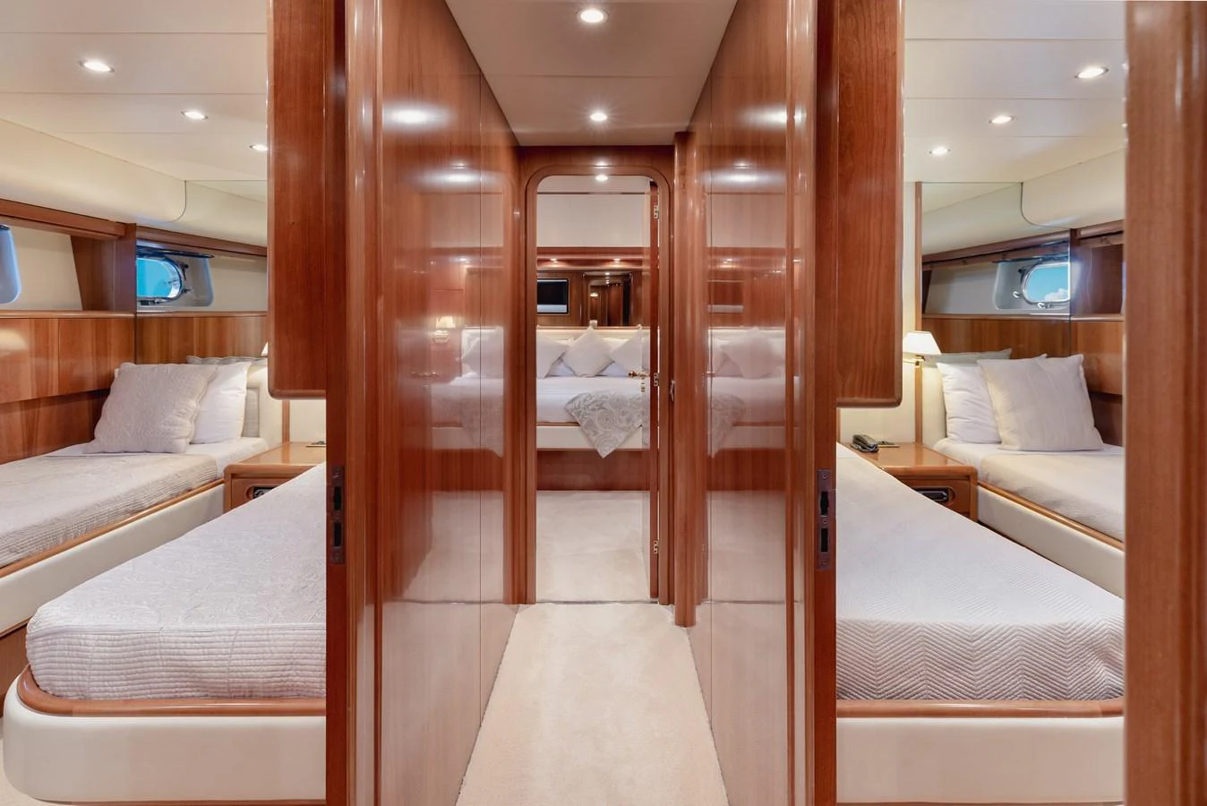 The guest stateroom features twin beds with luxurious bedding and warm wood finishes. aboard LADY MAUREEN Yacht for Sale