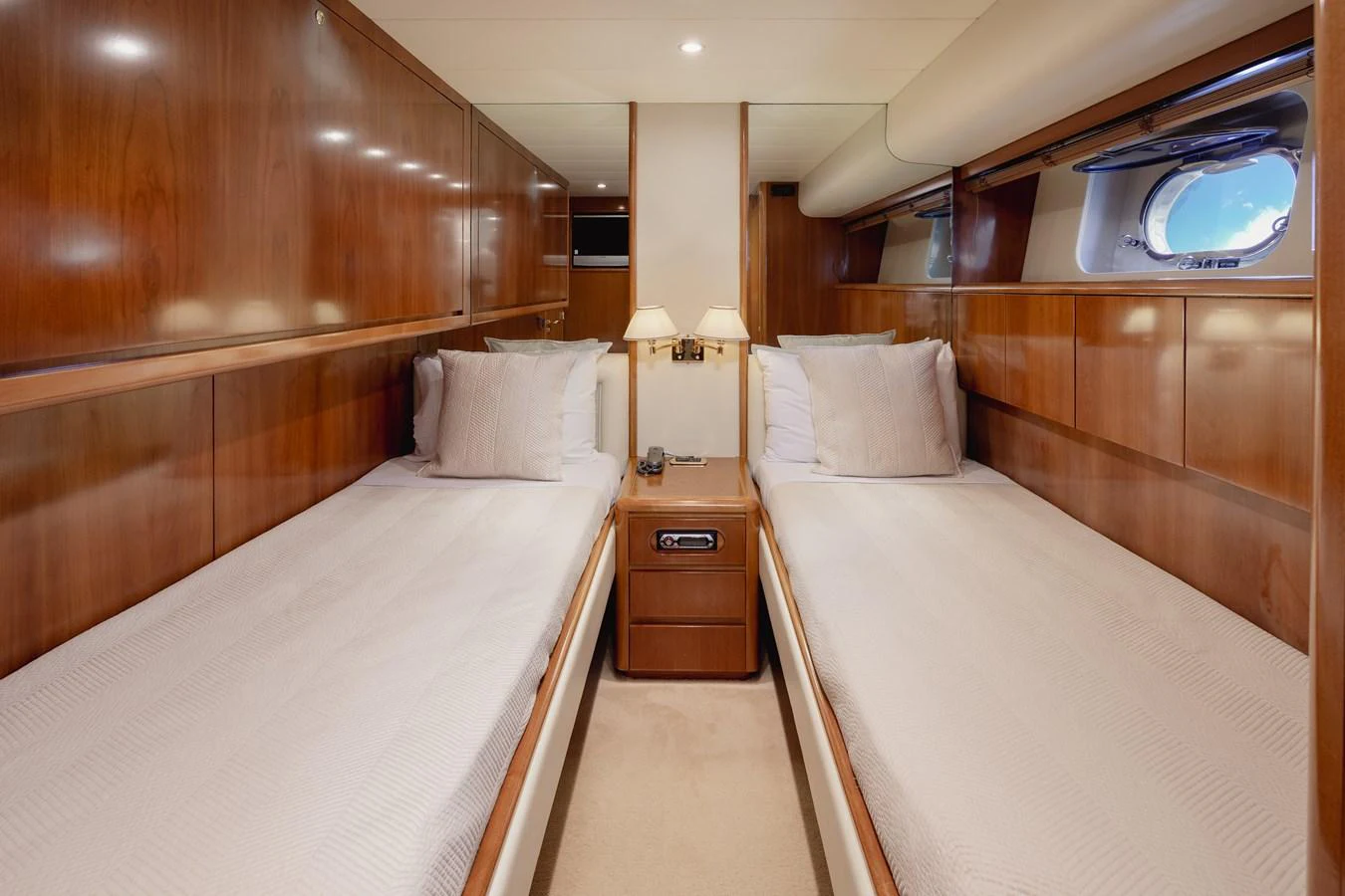 The twin stateroom features two comfortable single beds with elegant wooden paneling and ample natural light. aboard LADY MAUREEN Yacht for Sale