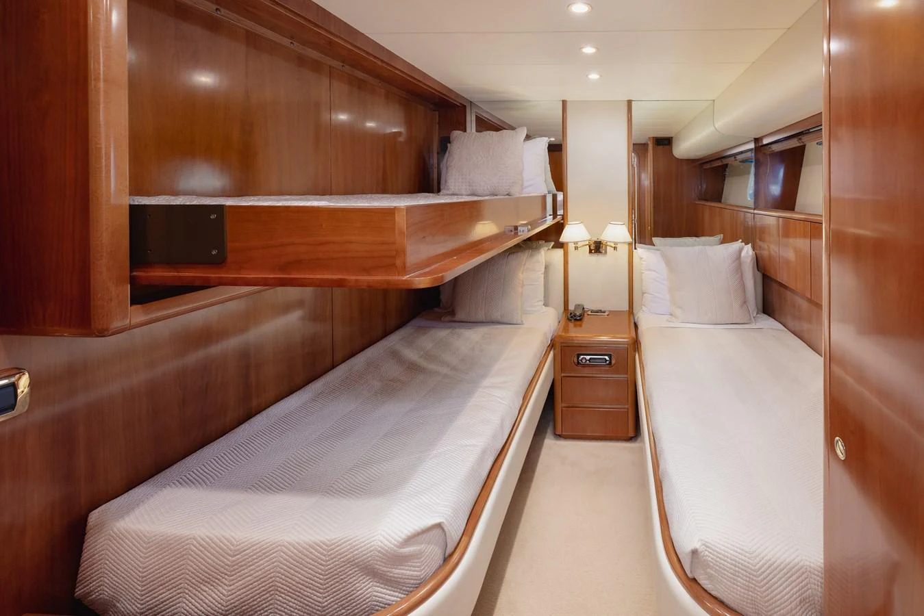 The guest cabin features twin beds with a warm wood finish and soft lighting for a cozy atmosphere. aboard LADY MAUREEN Yacht for Sale