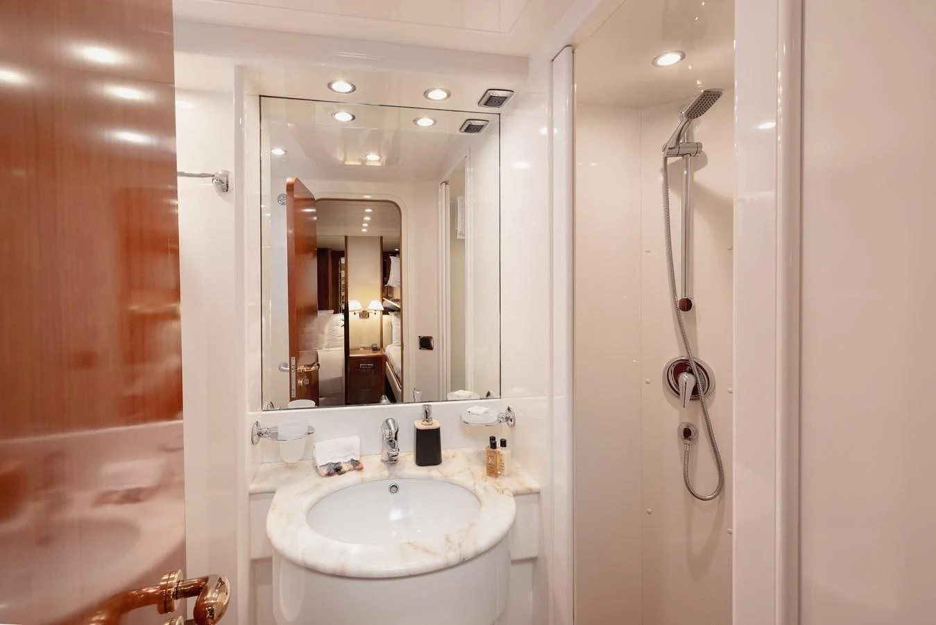The yacht's bathroom features a sleek design with a marble countertop and modern fixtures. aboard LADY MAUREEN Yacht for Sale
