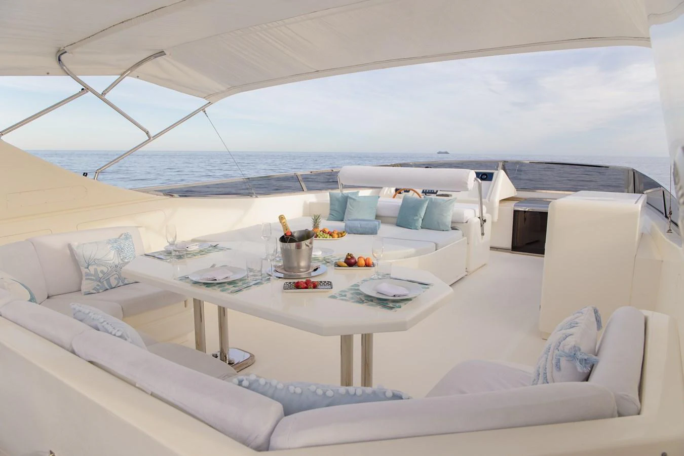 The flybridge offers a luxurious outdoor dining area with a stunning ocean view. aboard LADY MAUREEN Yacht for Sale