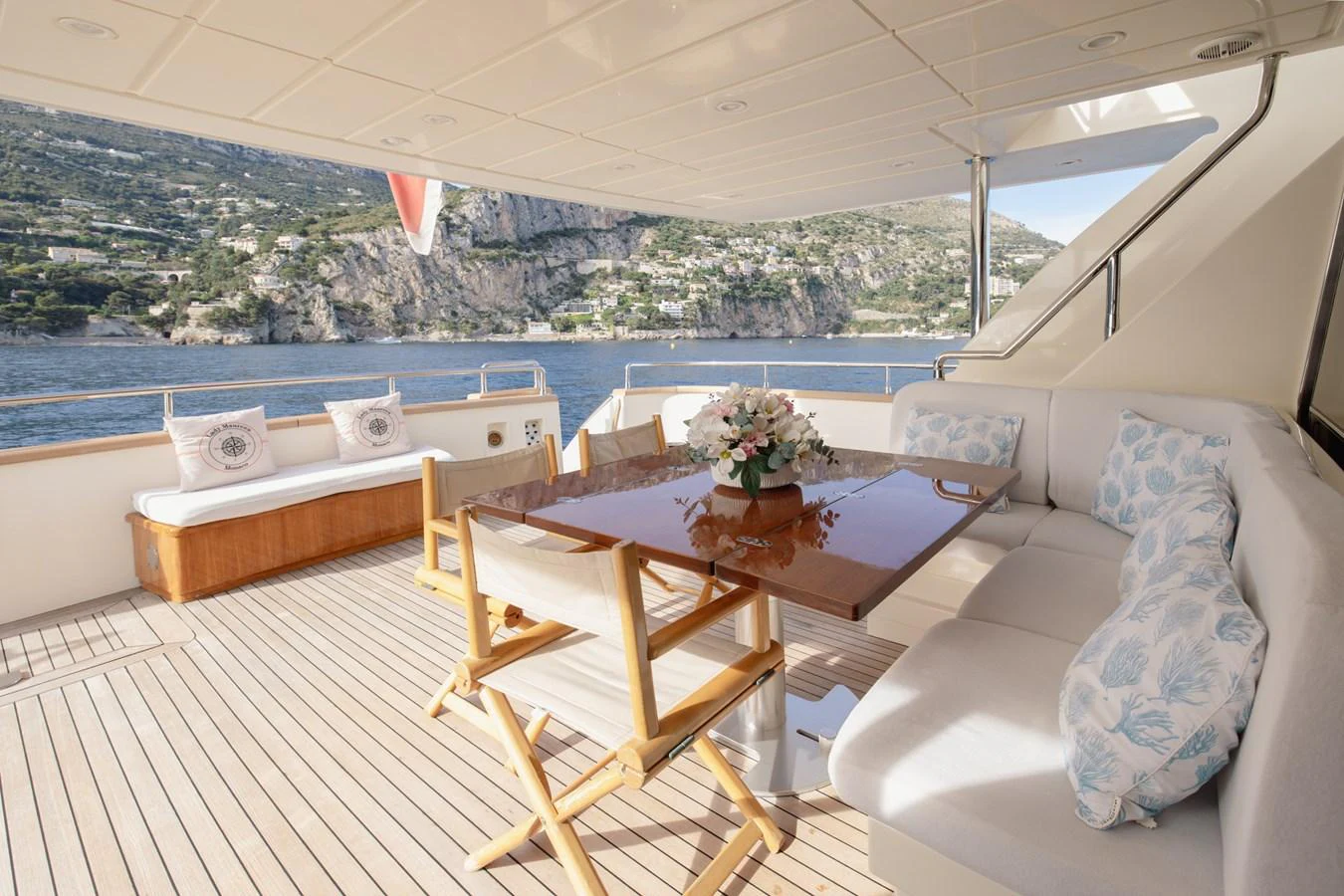 The aft deck offers a comfortable seating area with a dining table, perfect for enjoying meals with a scenic view. aboard LADY MAUREEN Yacht for Sale