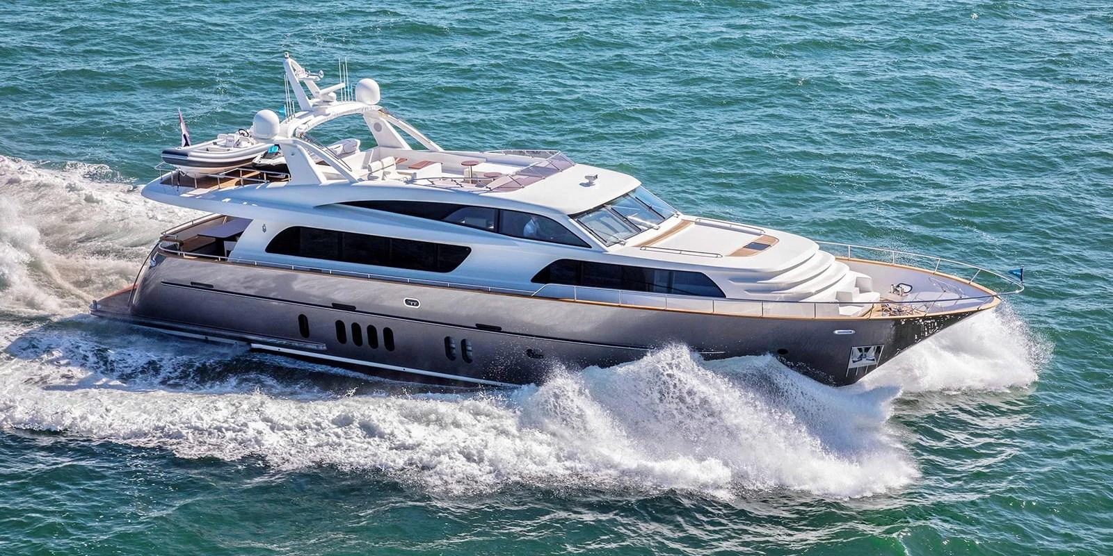 A sleek and modern yacht cruises through the open water, showcasing its elegant design and powerful performance. aboard NICOSTASIA Yacht for Sale