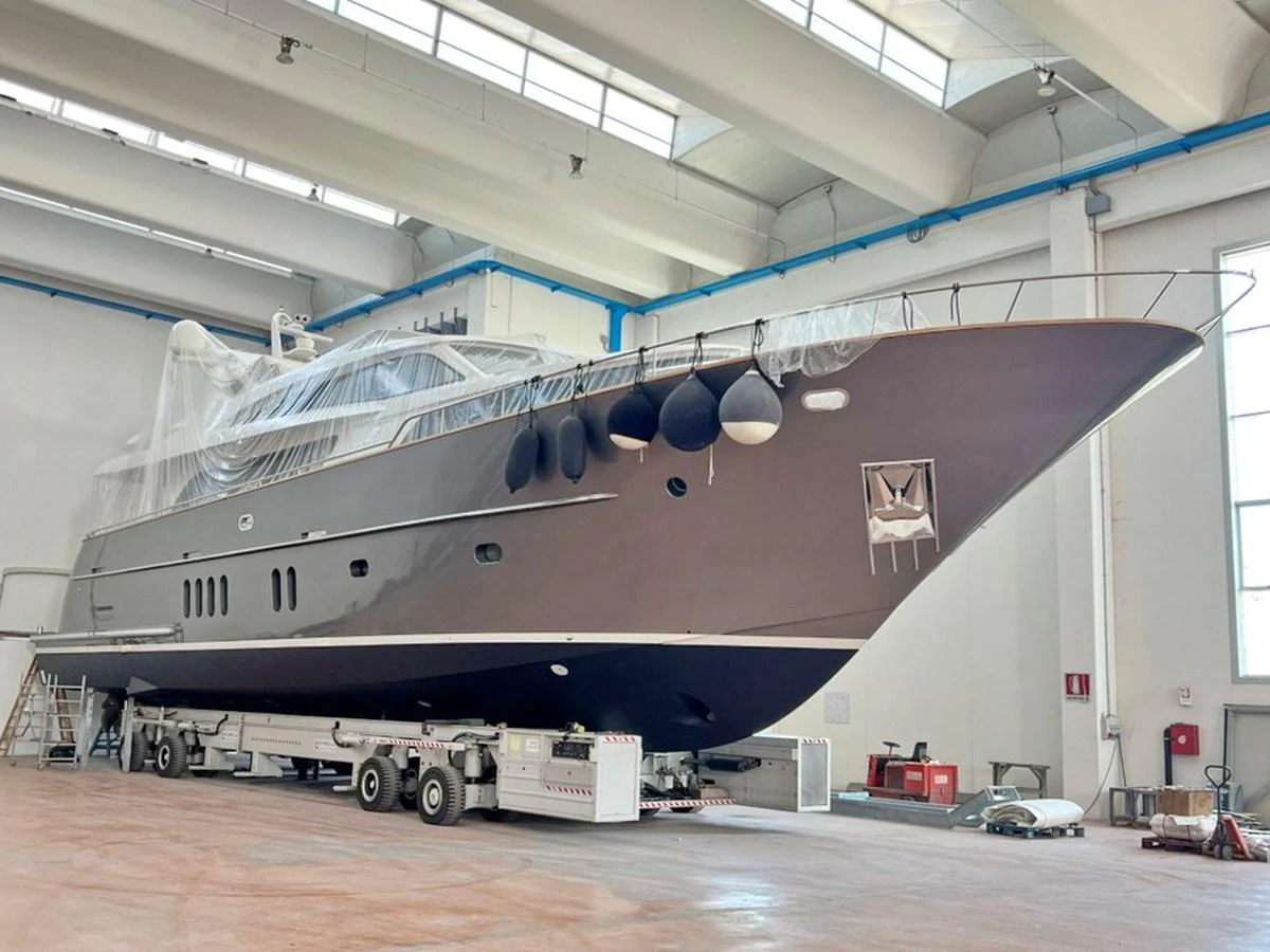 The yacht is shown in a shipyard, elevated on a platform for maintenance or construction. aboard NICOSTASIA Yacht for Sale