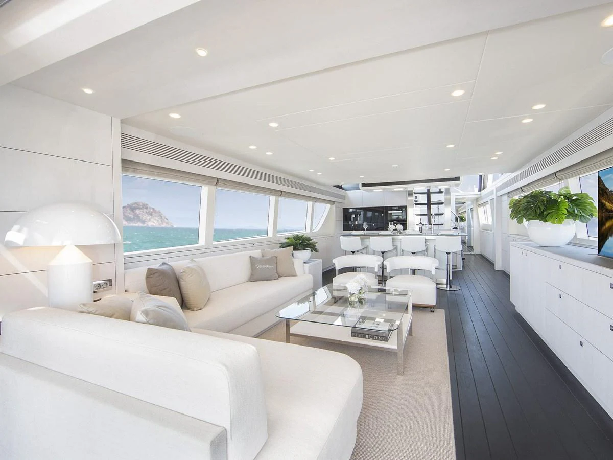 The yacht's salon features a spacious and modern design with ample seating and large windows offering stunning ocean views. aboard NICOSTASIA Yacht for Sale
