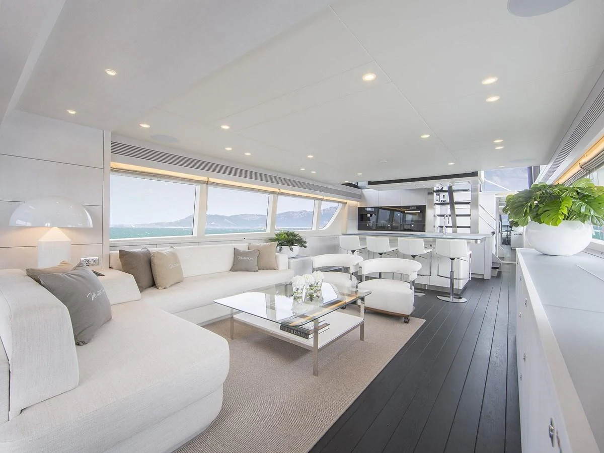 The salon features a spacious and modern design with ample seating and natural light. aboard NICOSTASIA Yacht for Sale