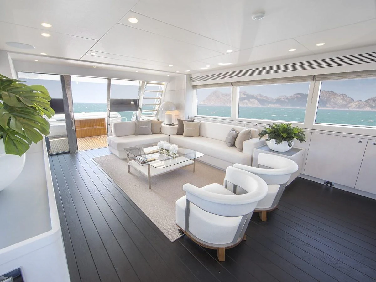 The salon offers a spacious and elegantly designed area with panoramic views and luxurious seating. aboard NICOSTASIA Yacht for Sale