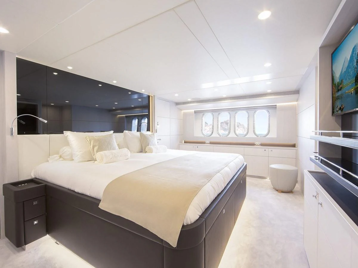 The master stateroom features a luxurious bed, modern decor, and ample natural light. aboard NICOSTASIA Yacht for Sale