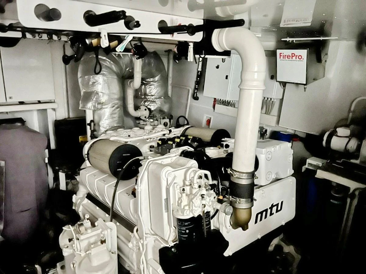 The image showcases the engine room featuring a powerful MTU engine. aboard NICOSTASIA Yacht for Sale