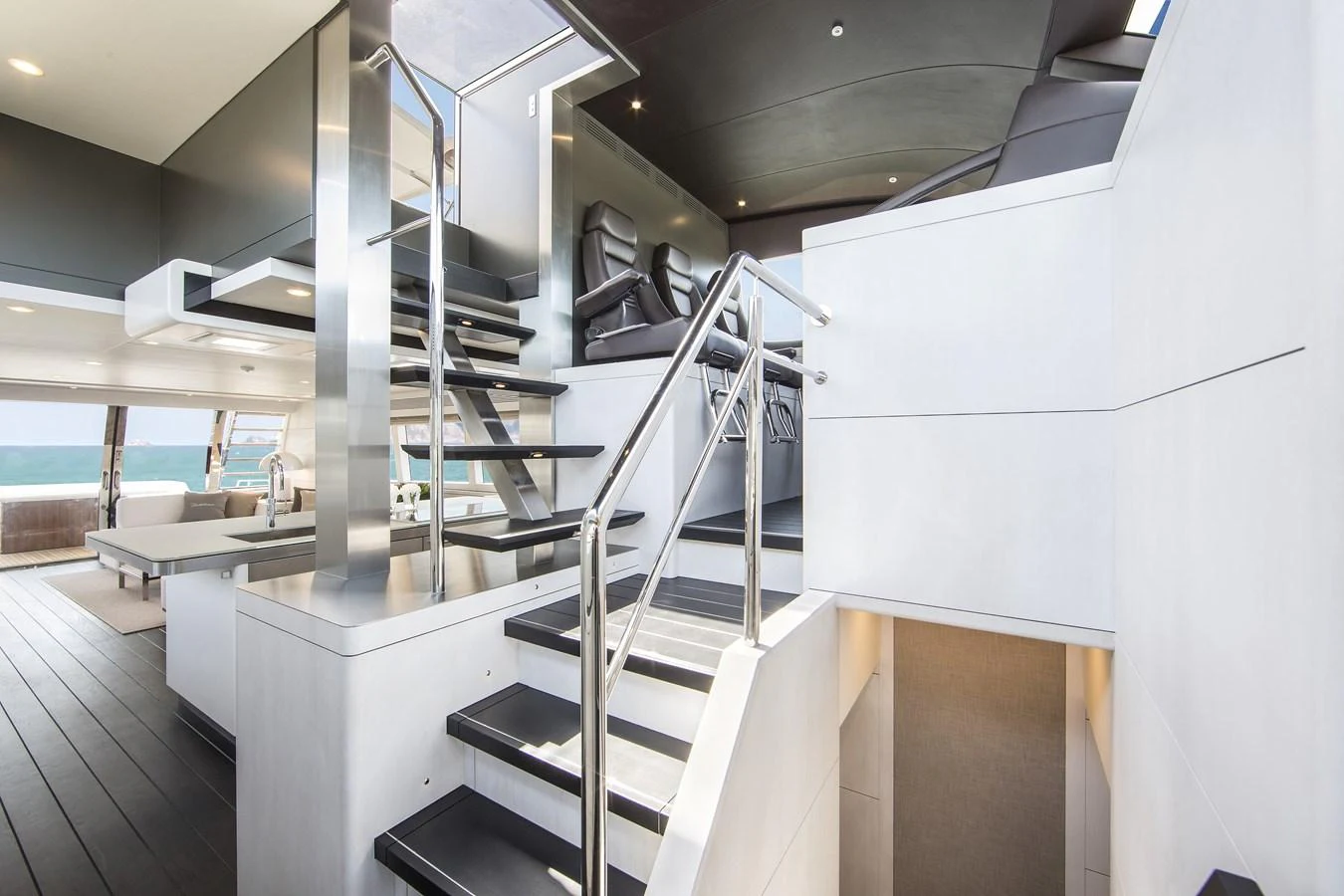 A modern yacht interior featuring a sleek staircase with stainless steel railings and contemporary design elements. aboard NICOSTASIA Yacht for Sale