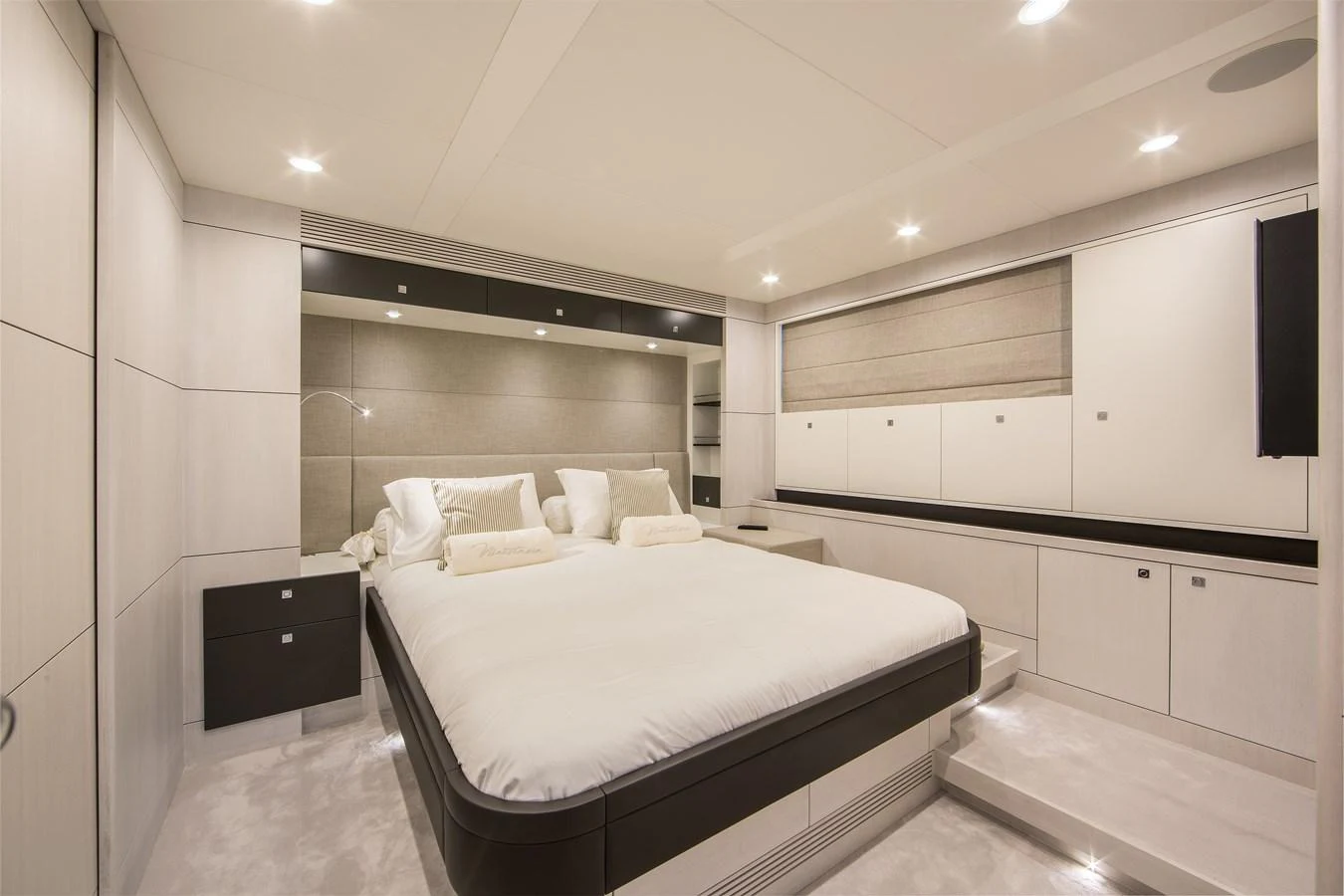 The master stateroom features a spacious bed with modern, elegant decor and ample storage. aboard NICOSTASIA Yacht for Sale