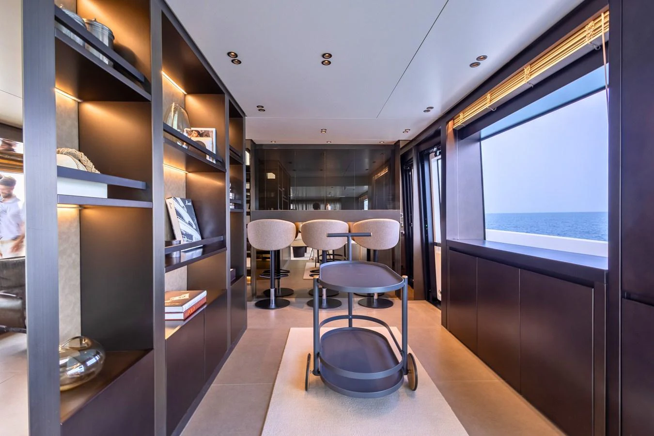 The yacht's interior features a stylish and modern lounge area with ample natural light and elegant furnishings. aboard ILIA Yacht for Sale