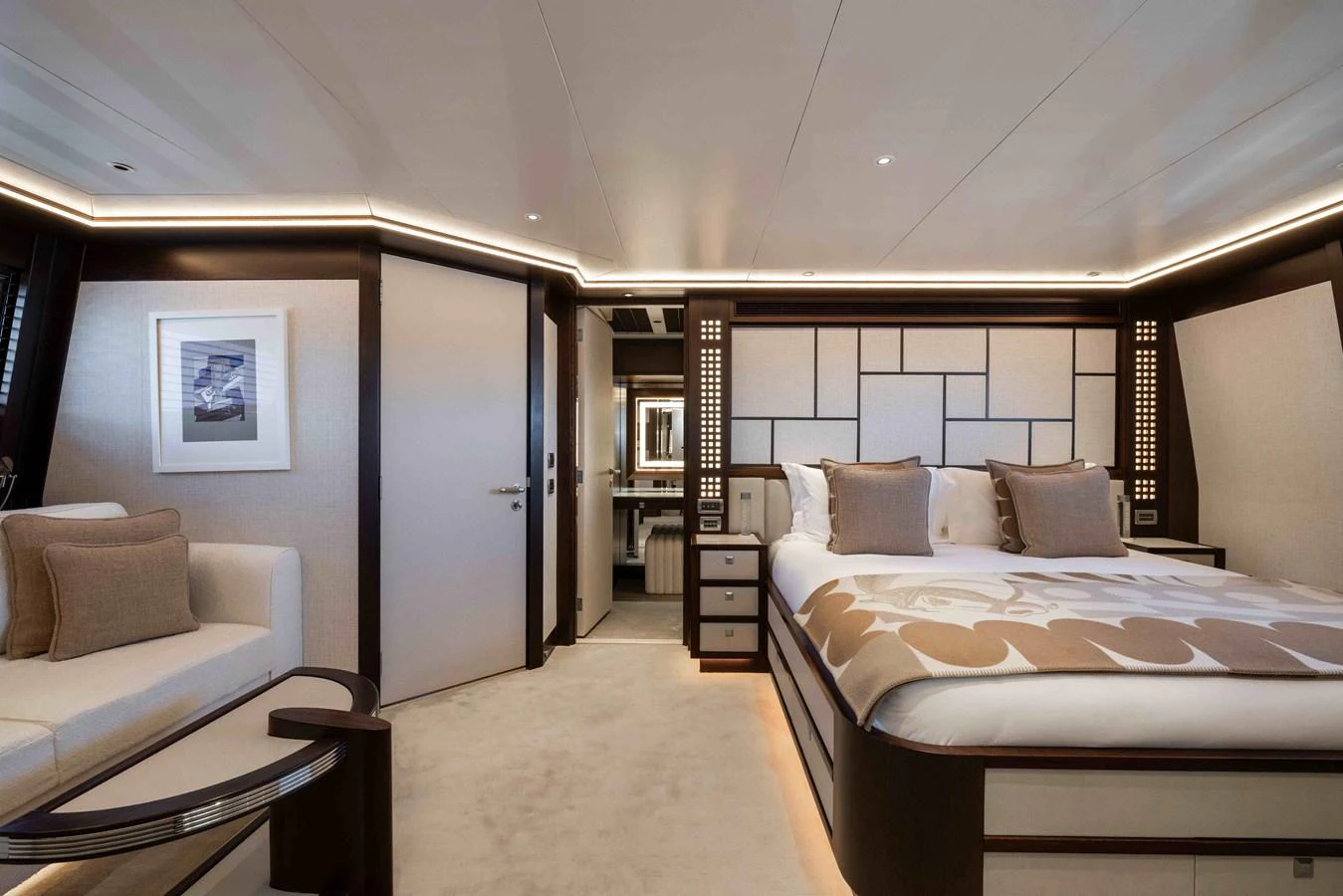 The master stateroom features a luxurious bed, elegant decor, and ample lighting. aboard AURA Yacht for Sale
