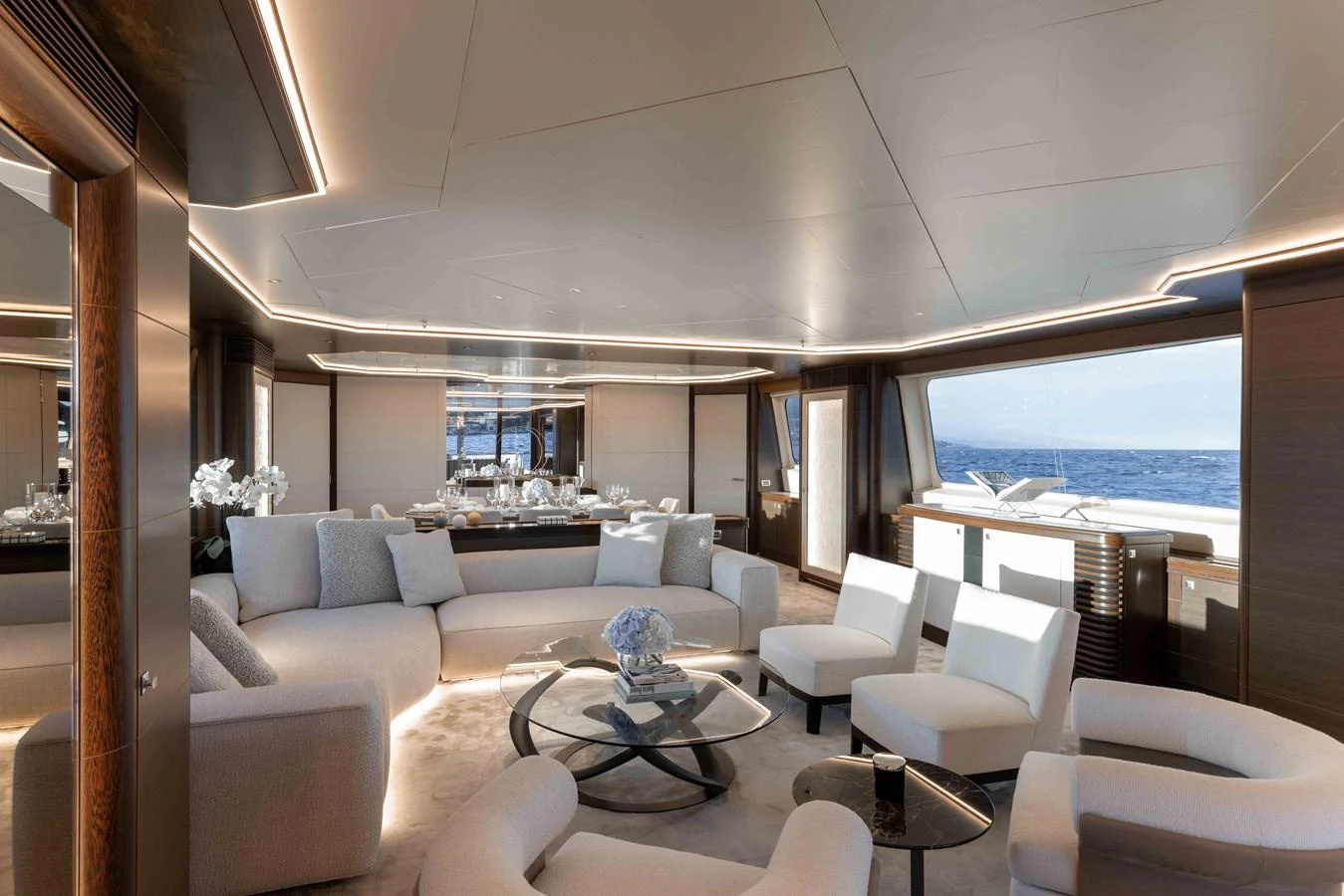 The yacht's salon features luxurious seating with panoramic ocean views. aboard AURA Yacht for Sale