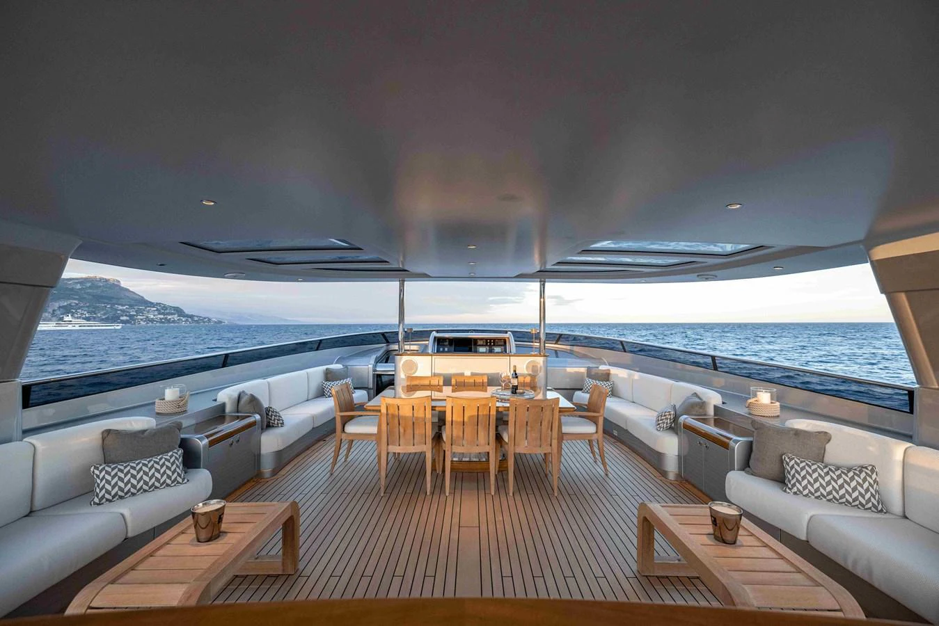 The aft deck offers a spacious and elegant outdoor seating area with stunning ocean views. aboard AURA Yacht for Sale